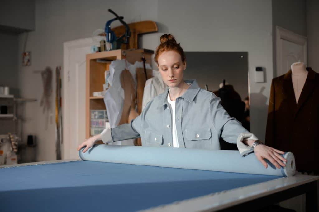 Woman cutting fabric wishing she had purchased poppie cotton