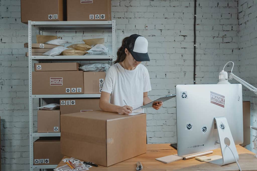 Girl filling orders at the poppie cotton shipping desk